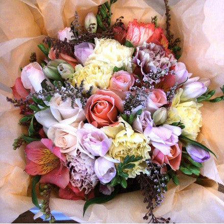 Our most popular arrangement.  A sweet cottage mix of traditional lemons, lilacs, pinks and apricots.