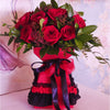 Moulin Rouge. A dozen red roses styled with complementing foliage, hand tied and arranged in a handmade lace trimmed vase box. 