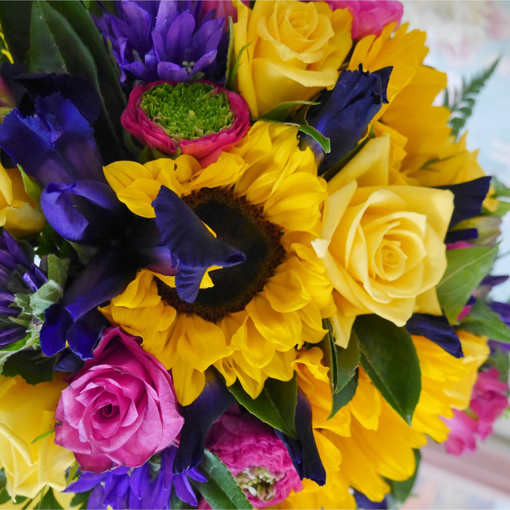 Beau  Soliel or Beautiful Sun - Round form Bouquet.   A sunny mix of seasonal flowers that will brighten anyone's day.  