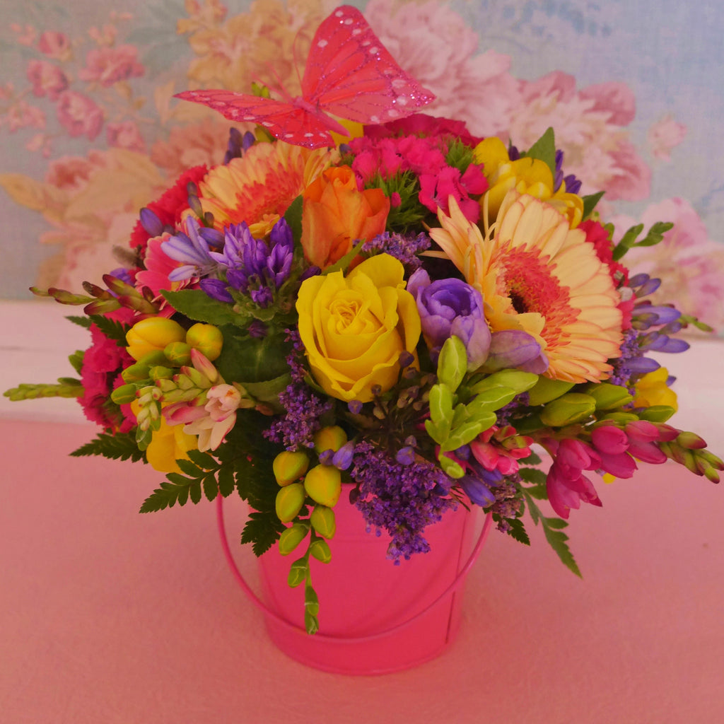 Madame Butterfly. Bright posy in a matching water-filled vase box or if you prefer, a cute tin pail. Butterfly atop. 