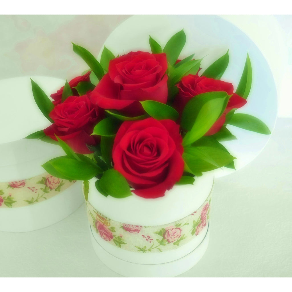 Linen Rose.  A vintage or cottage style arrangement of premium NZ red roses and superior foliage in a quality floral "hatbox" finished with a stylish linen rose sash.