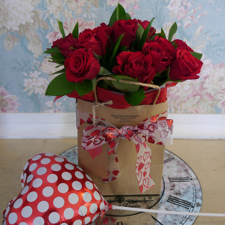 12 Premium Red Roses, wrapped in a Kraft Bag with Heart Ribbon and Polka Dot Heart Balloon